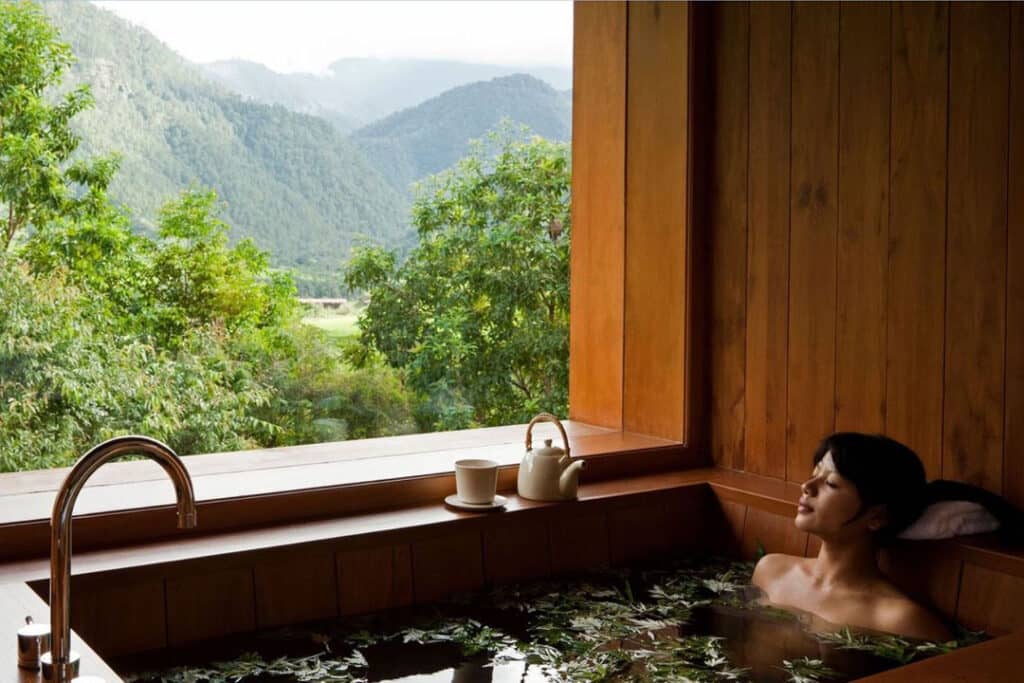 Woman Enjoying Hot Stone Bath in Bhutan